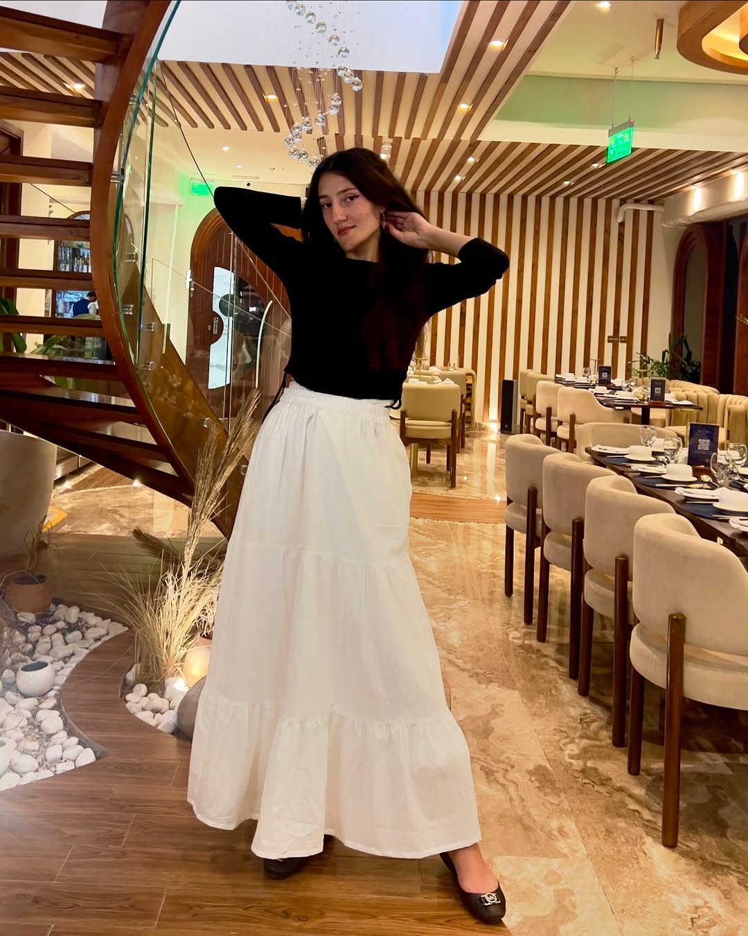 Chic black top complements flowing white ⁤skirt