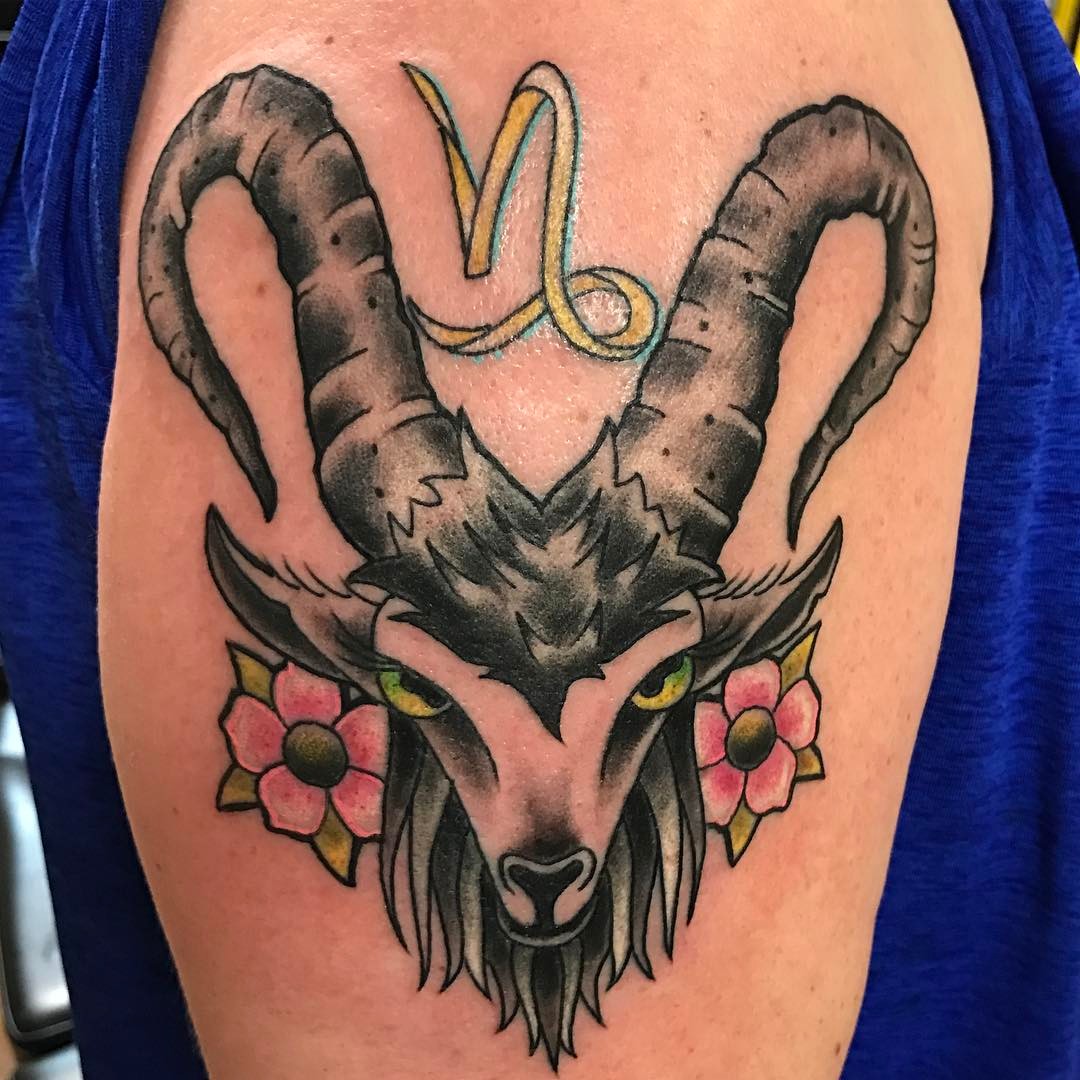 stylish Capricorn goat tattoo with floral accents