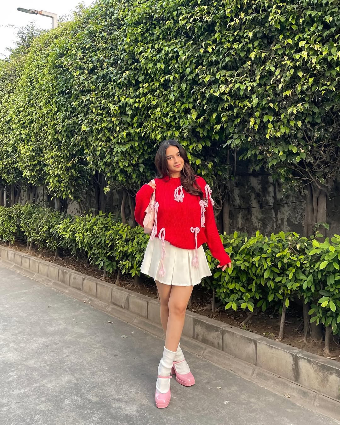 Chic​ white‌ skirt with vibrant red sweater