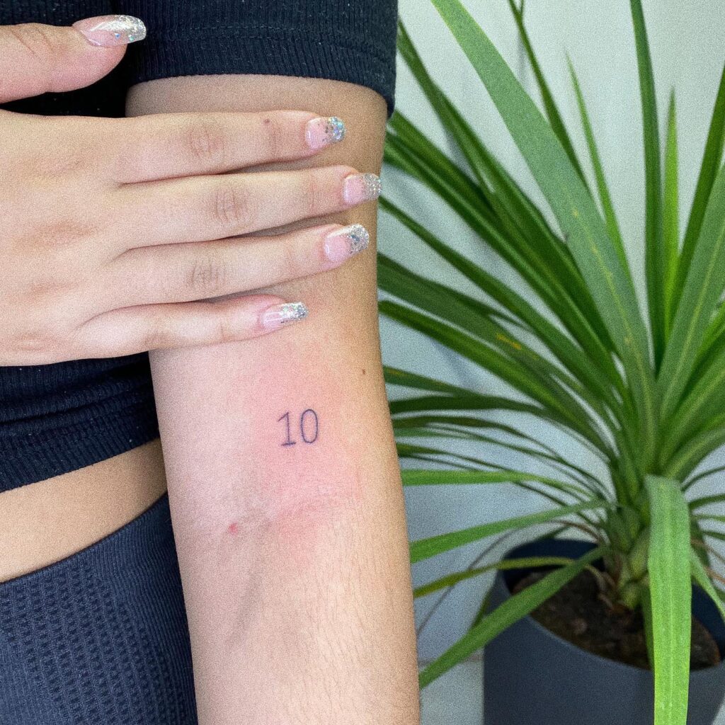 '10' Angel Number Tattoo on the Above the Elbow: Perfect Ten