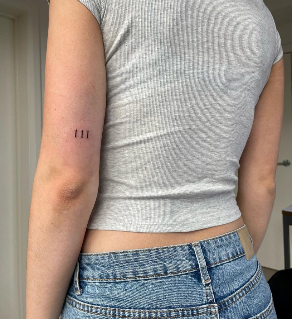 '111' Angel Number Tattoo on the Back of the Above the Elbow: Numerical Enigma