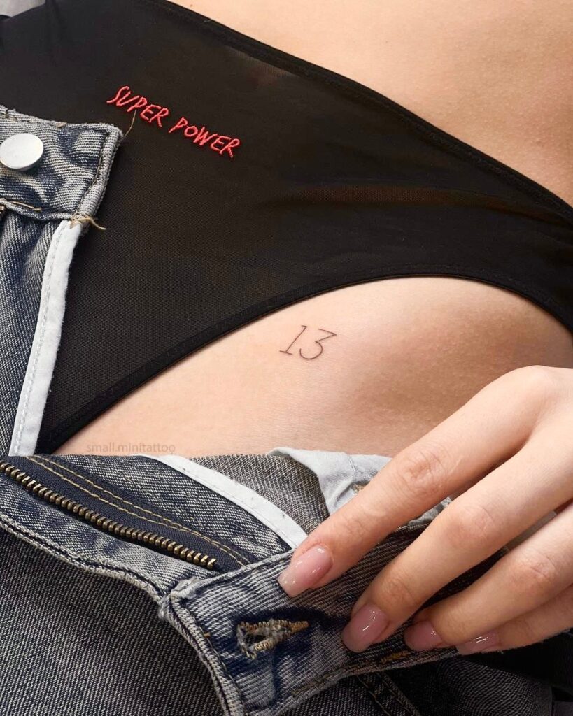 '13' Angel Number Tattoo on the Hip, a Symbol of Transformation and Luck: Numerical Elegance