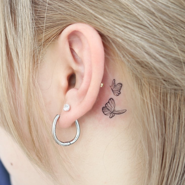 2 butterflies flying together tattoo female behind the ear dual harmony