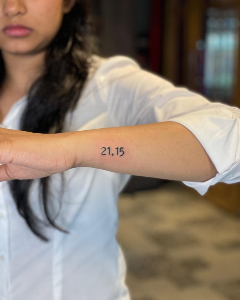 21.15 side forearm tattoo for females in bold blackwork: time signature