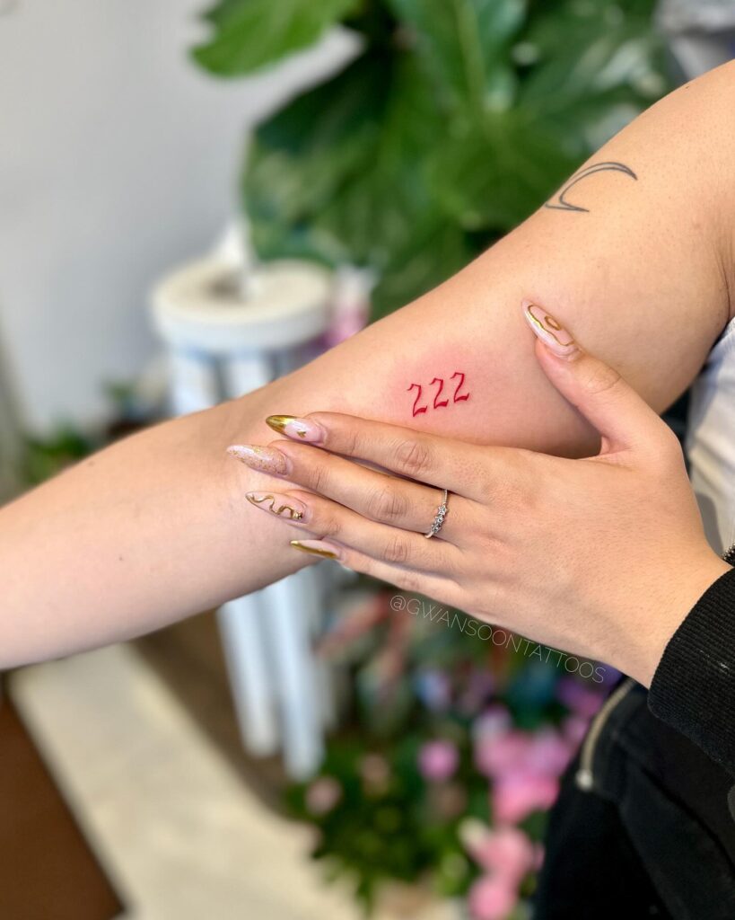 222 Red Color Inner Bicep Tattoo for Females, a Chic Mark: Inner Bicep Elegance 
