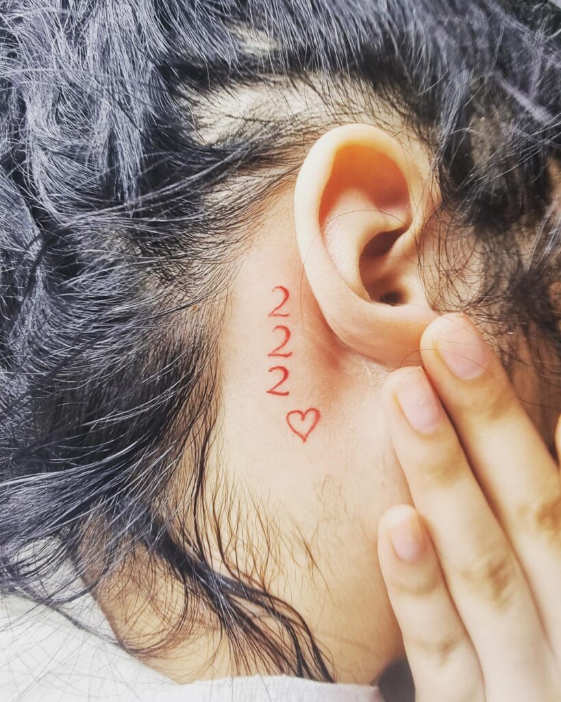 222 Tattoo with Outline Heart Behind the Ear, a Red Romantic Gesture: Ear Embrace 