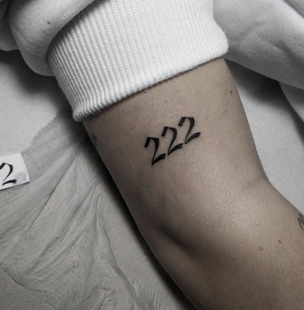 '222' Text Lettering Tattoo Above the Elbow, a Stylish Statement: Triple Deuce Elegance 