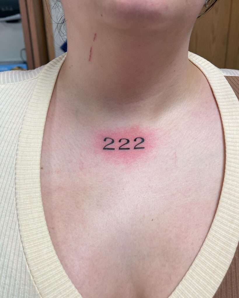 222 Voice Just Below Throat Tattoo for Women in Black Color, a Symbol of Empowerment: Voice of Strength 