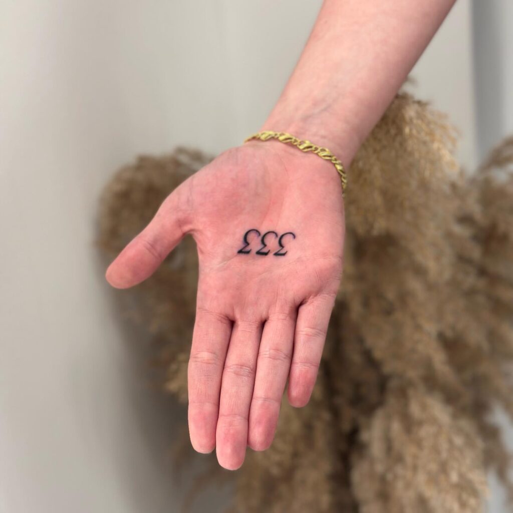 333 Inner Hand Tattoo on the Palm in Blackwork Ink Adding a Dash of Mystique to the Hand Canvas: Triple Treasures