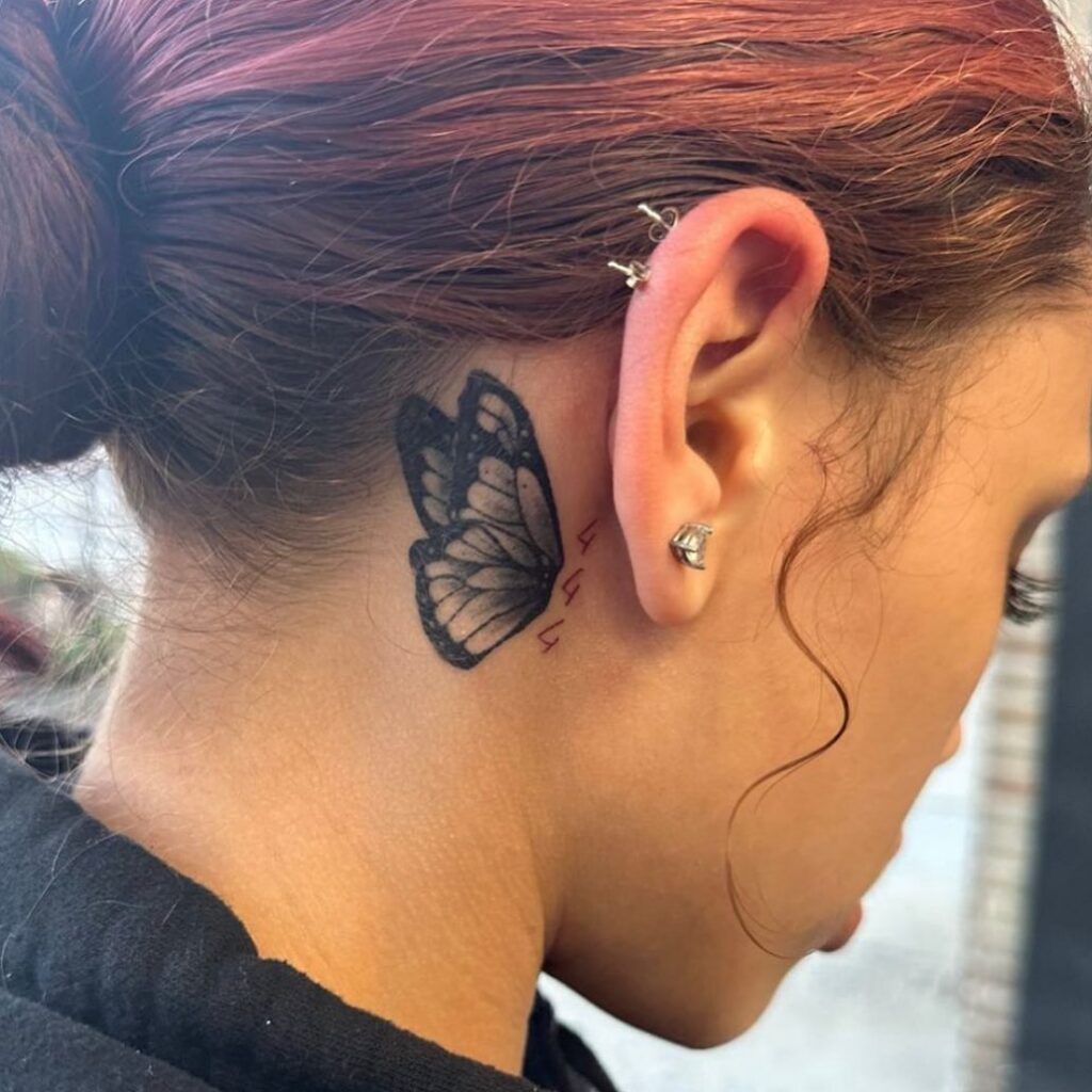 444 and beyond black butterfly tattoo evoking mystery behind the ear