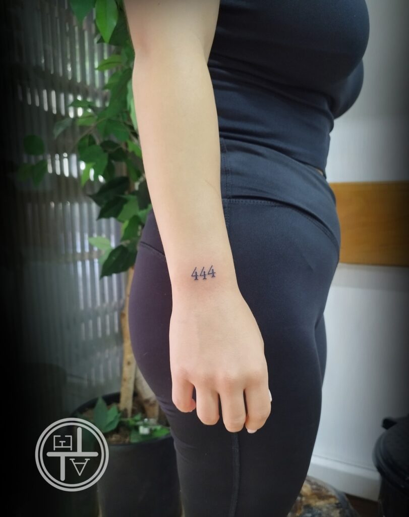 444 number tattoo on the outer wrist for girls a unique symbol