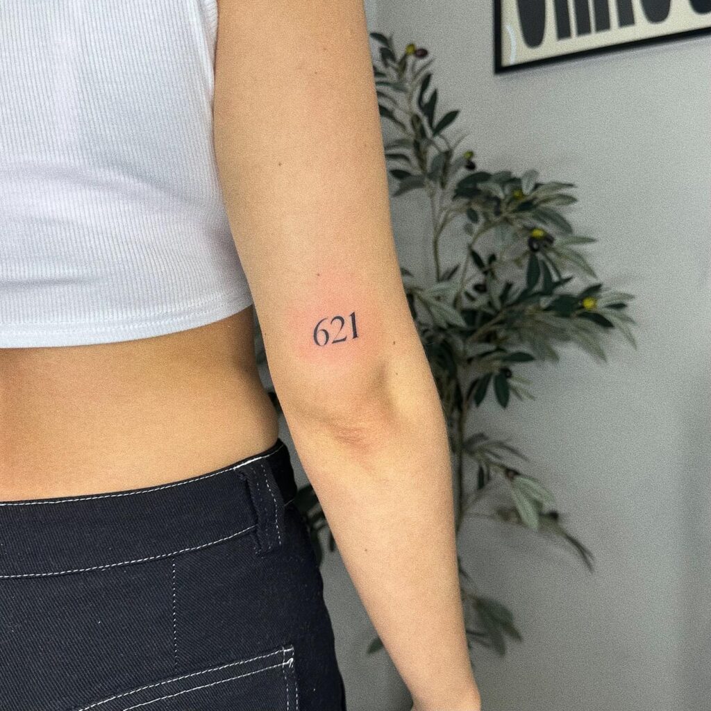'621' Text Tattoo on the Back of the Above the Elbow: Numerical Harmony