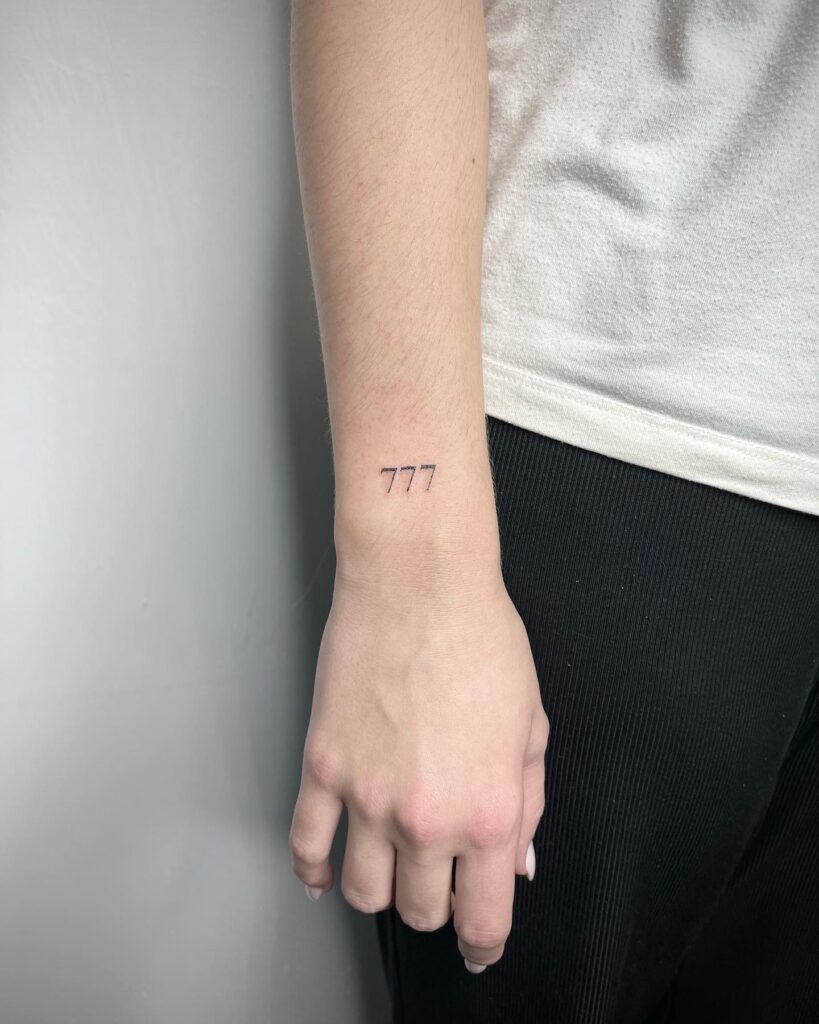 777 angel number fineline wrist tattoo, a subtle reminder of spiritual significance divine triple seven 
