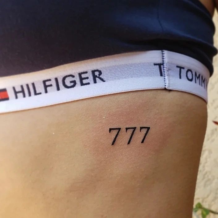 777 black ink tattoo adding a touch of intrigue to the ribcage ribcage radiance 