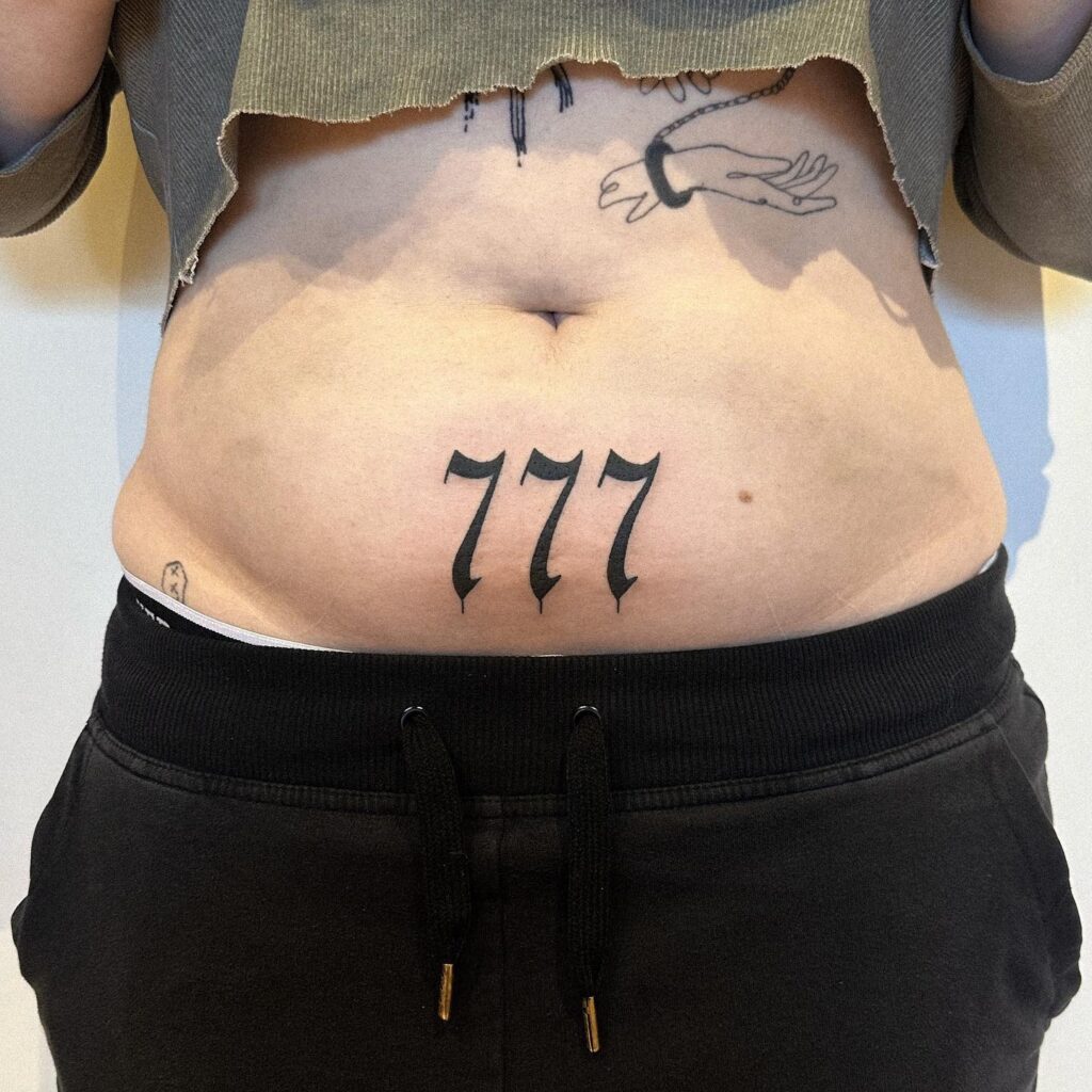 777 Illustration Black Work Tattoo on the Stomach: Mystical Core 