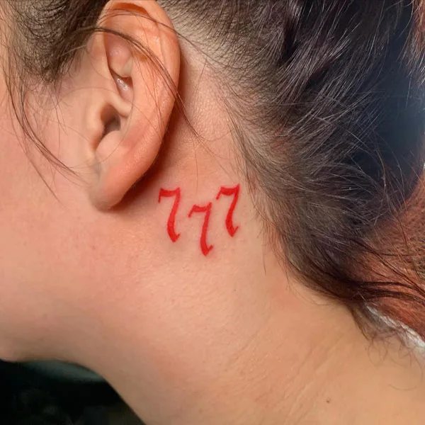 777 tattoo behind the ear