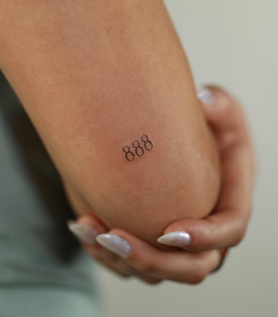888 Fineline Tattoo Above the Elbow: Numerical Elegance