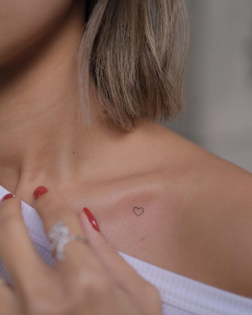 A delicate touch on the collarbone: tiny heart outline