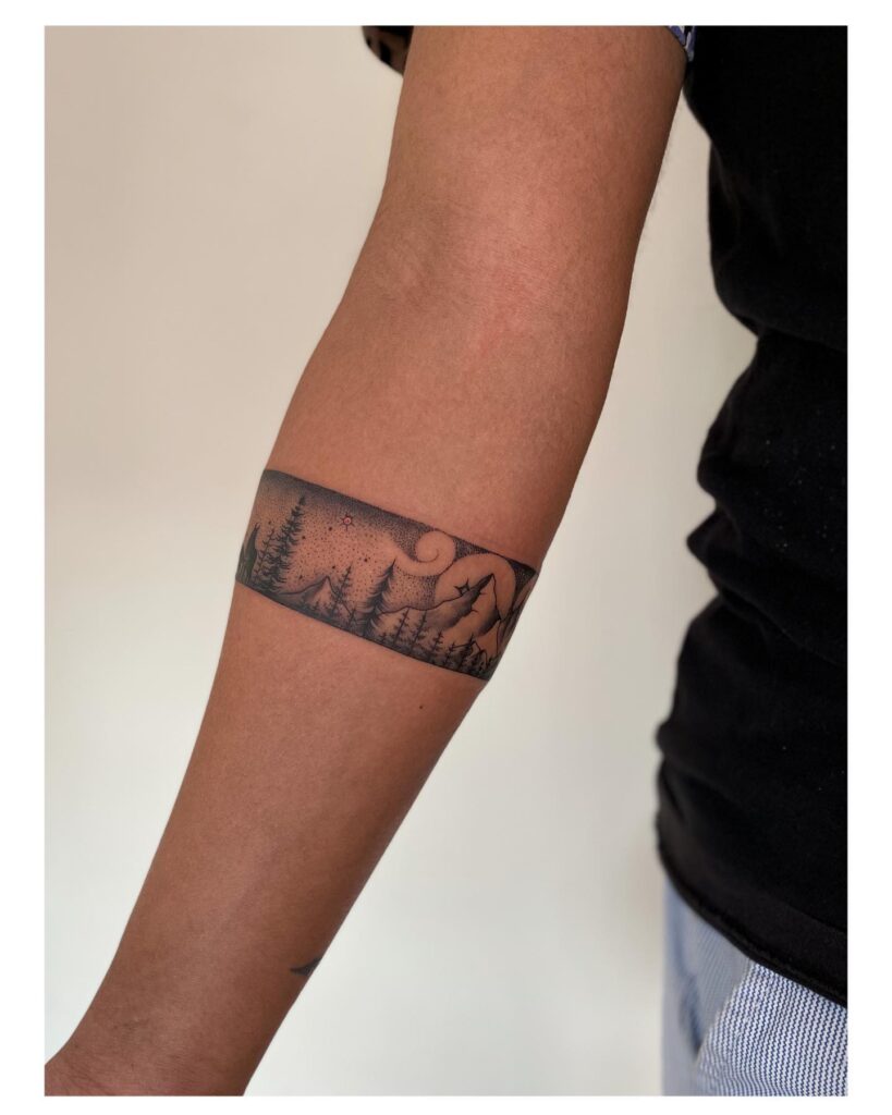 A distinctive twist howling wolves band forearm tattoo