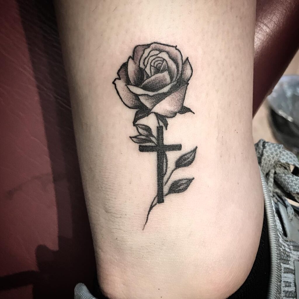 A Rose with a Cross Tattoo Above the Ankle, a Subtle Blackwork Design: Ankle Adornments