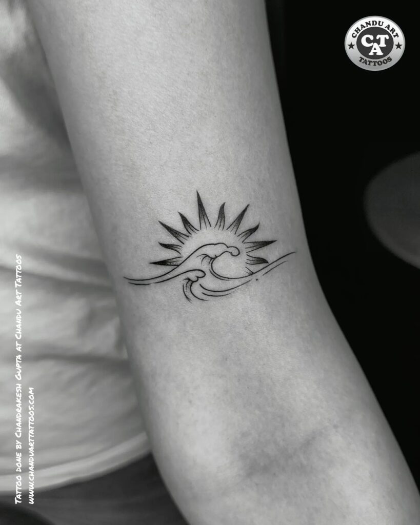 Above elbow sun and wave tattoo a radiant design