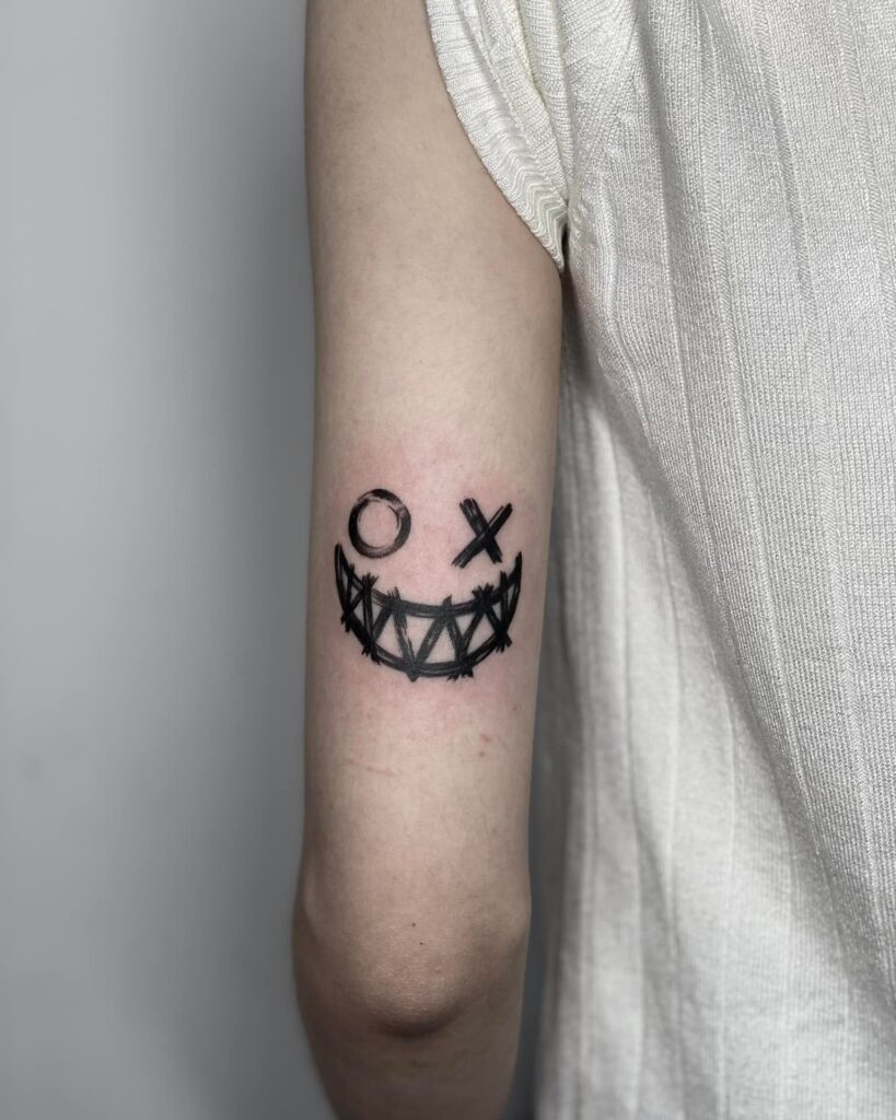 Above Elbow Tattoo Joker Smile Tattoo: Distinctive and Impressive Elbow Tattoo