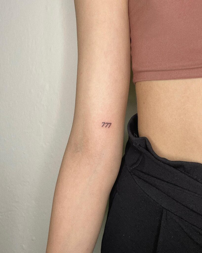 Above inner elbow tattoo, 777 in fineline for a chic and subtle design inner elbow whispers 