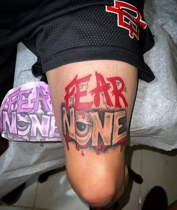 Above knee fear none tattoo
