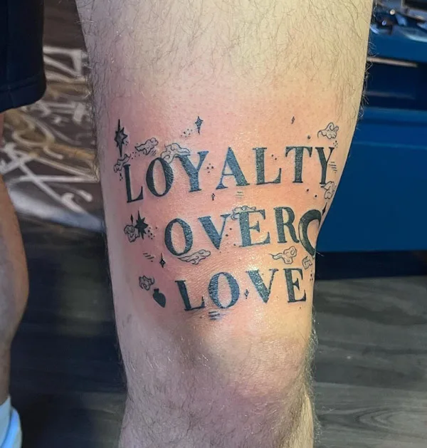 Above knee loyalty over love tattoo
