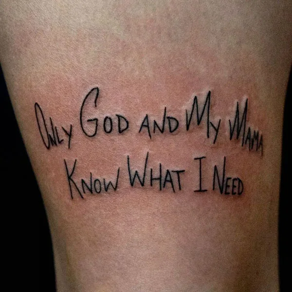 Above knee script tattoo