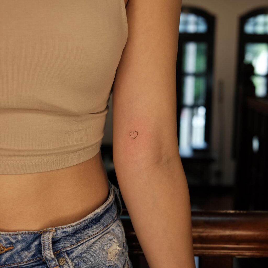 Above the elbow minimalist heart outline tattoo