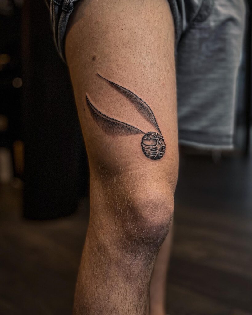 Above the thigh adventure men's golden snitch tattoo designs