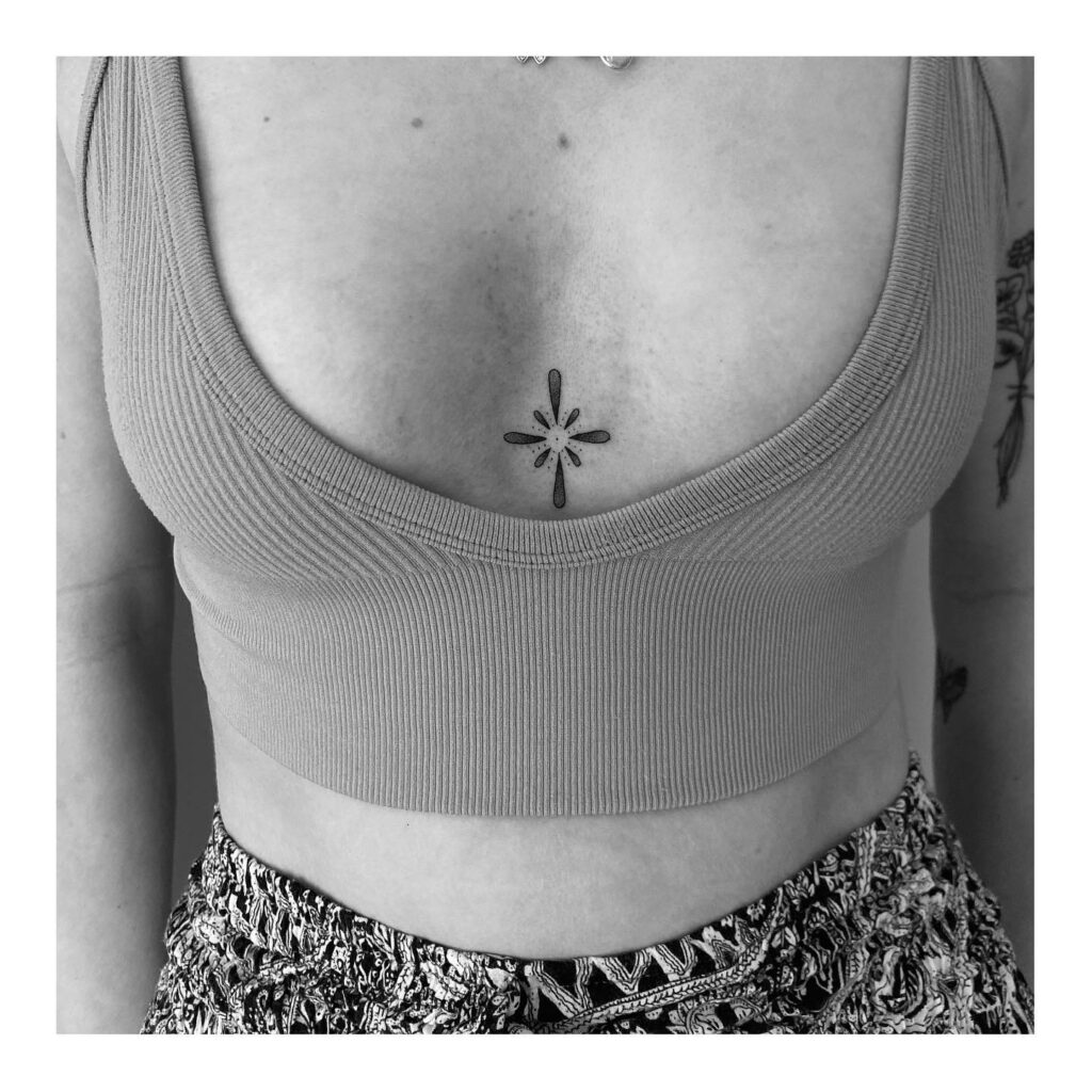 Abstract floral sternum tattoo with dot work inspiration