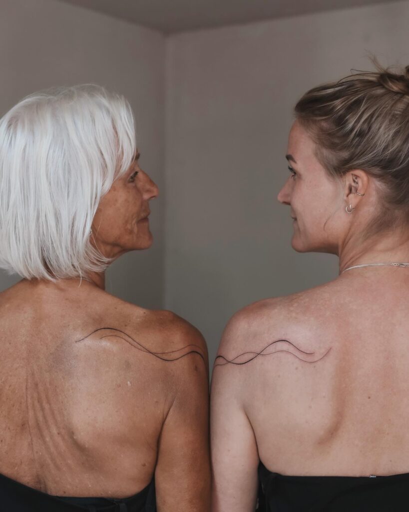 Abstract wave tattoo on shoulder for mother and daughter