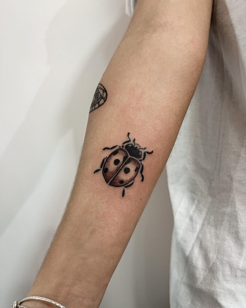 Adding a ladybug accent forearm tattoo ideas for men