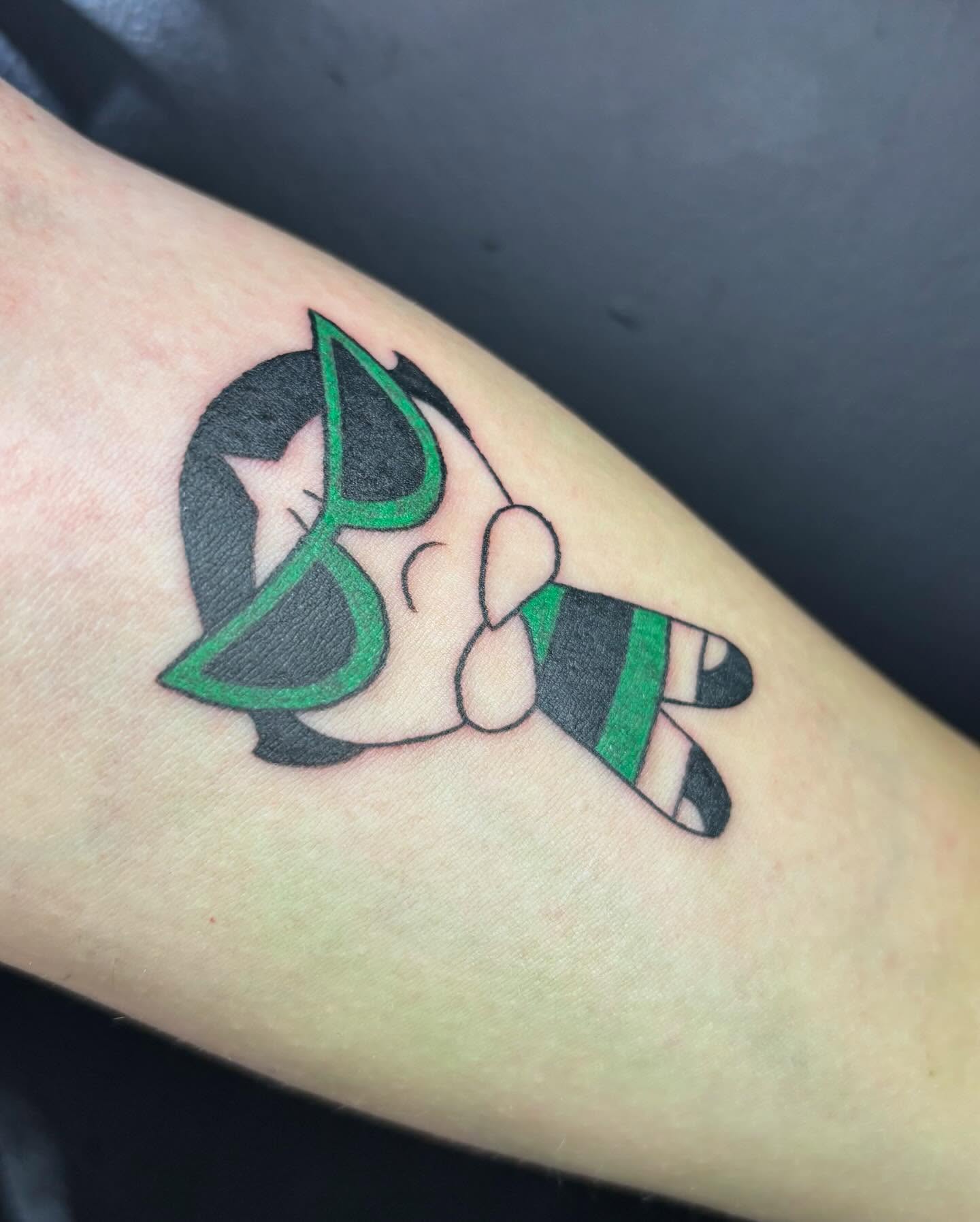 Adorable chibi-style Buttercup tattoo from The Powerpuff Girls with bold black outlines and vibrant green accents for a playful look Adorable chibi-style Buttercup tattoo from The Powerpuff Girls with bold black outlines and vibrant green accents for a playful look