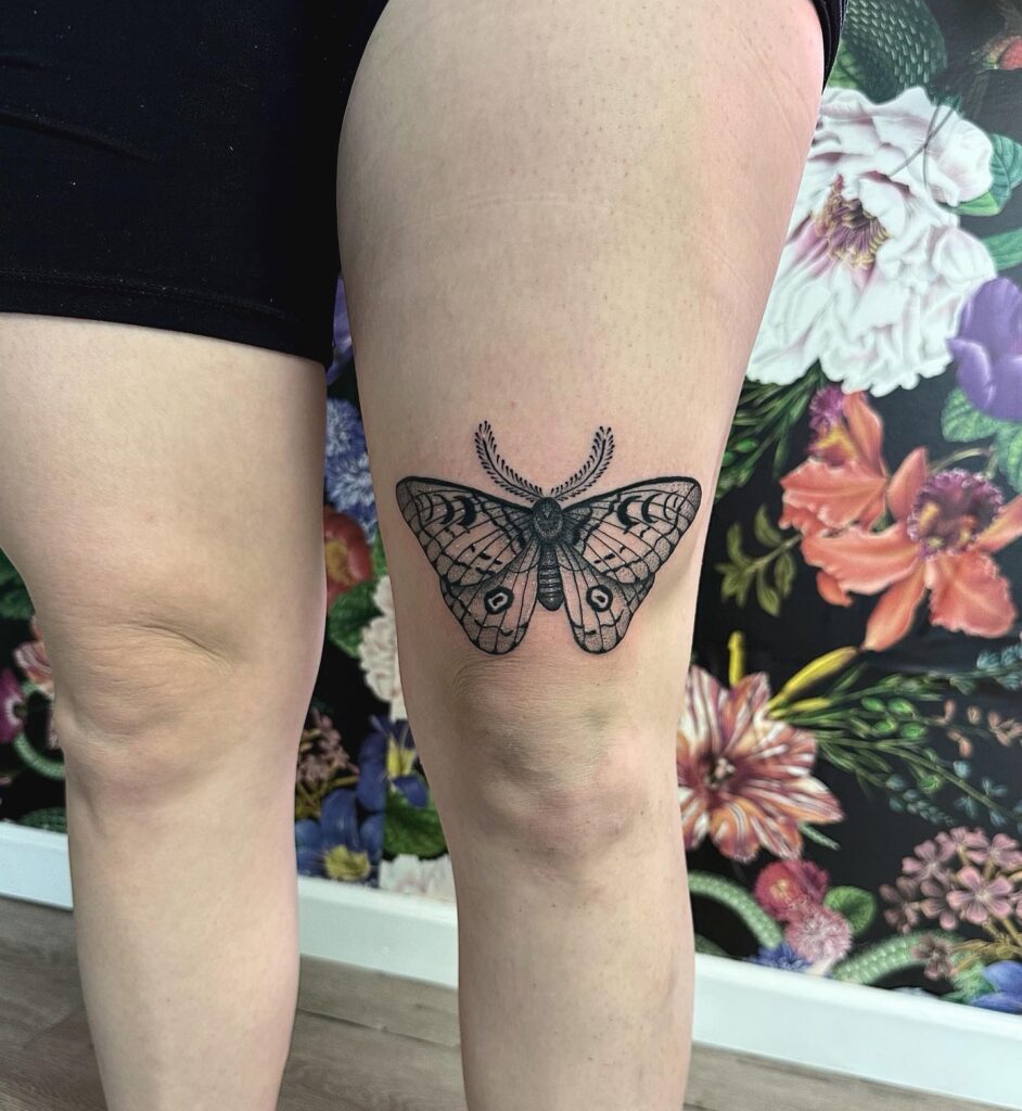 Amazing moth above the knee tattoo for women nocturnal art