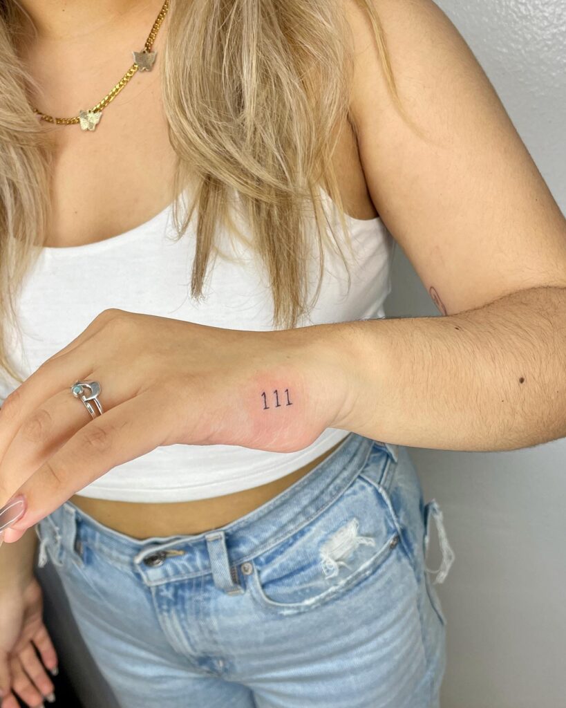 Angel number 111 tattoo on the side of the hand, a spiritual mark: celestial harmony
