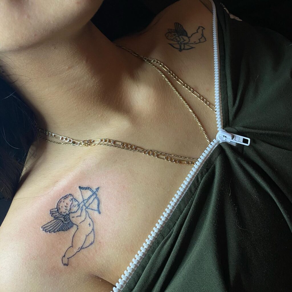 Angel shooting arrow tattoo on collarbone, symmetrical and angelically aligned celestial archery