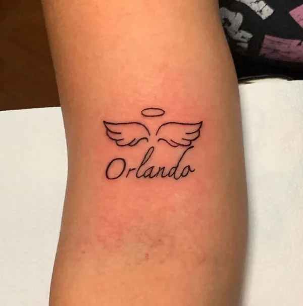 Angel wings name tattoo