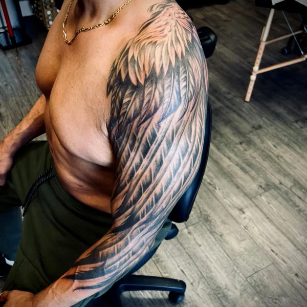 Angel wings sleeve tattoo