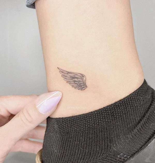 Angel wings tattoo on ankle