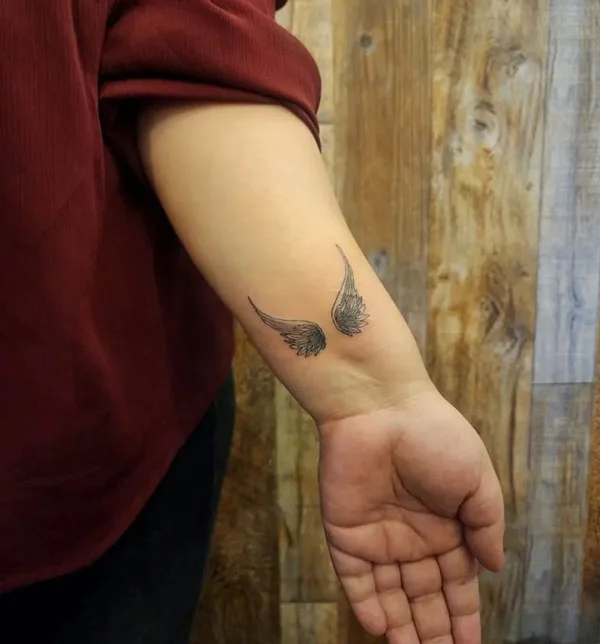 Angel wings tattoo on wrist 2