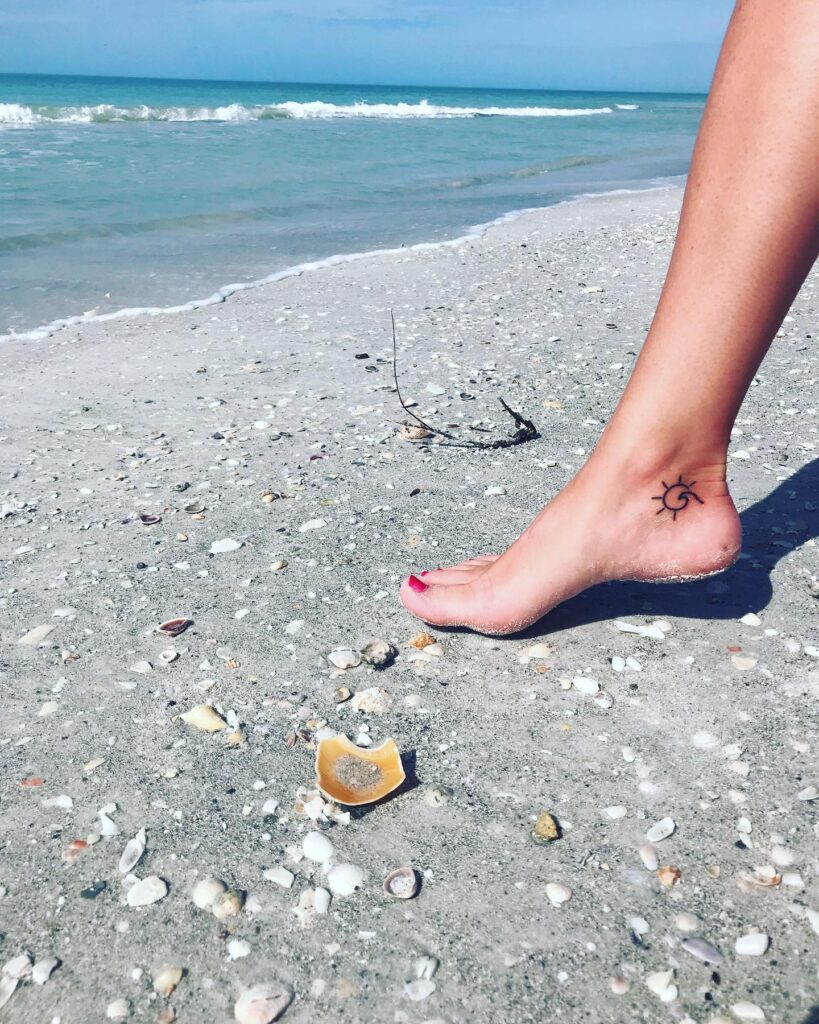Ankle wave and sun tattoos for girls on leg ocean-inspired and subtle body art