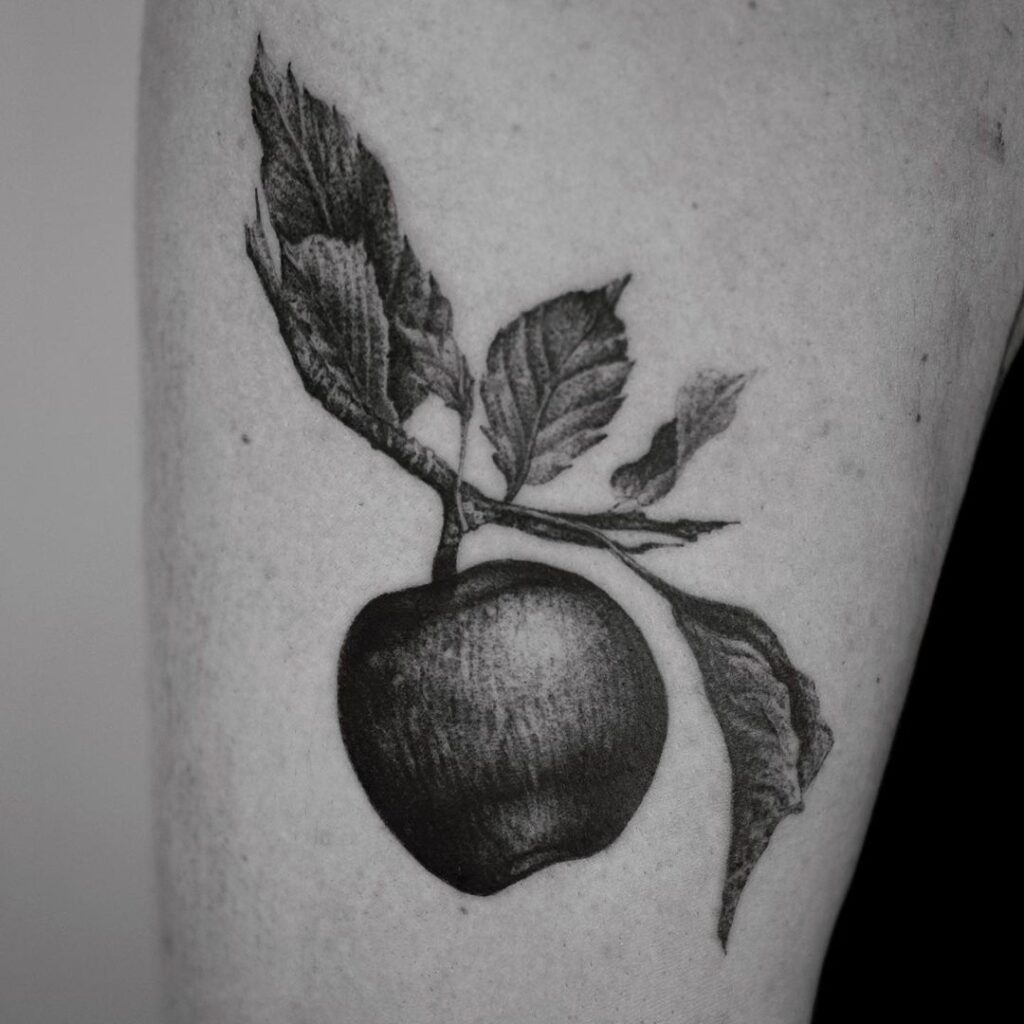Apple with leaves black and white tattoo above the knee thigh art