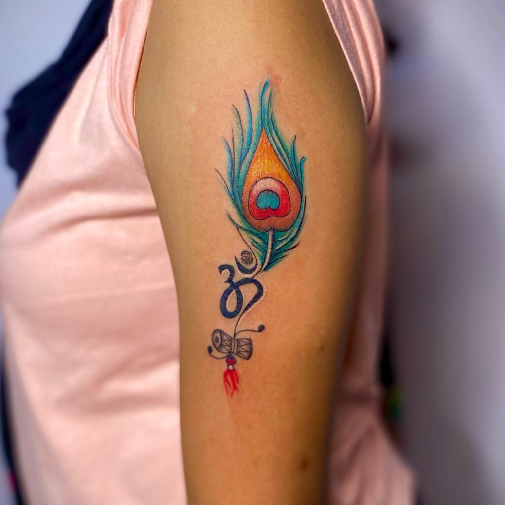 Arm Peacock Feather Tattoo for Females with Om Symbol and Damaru : Devotional and Stylish