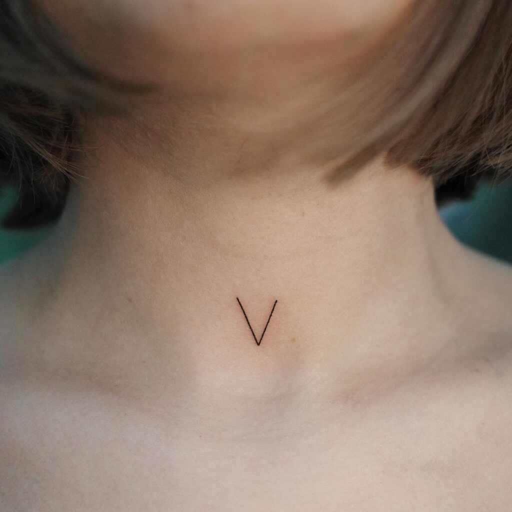 Attractive Front Neck Letter 'V' Tattoo Design for Females: Feminine Appeal, Enhancing Grace