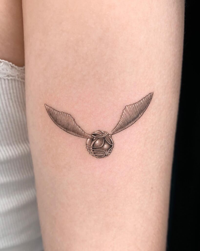 Back of the upper arm beauty golden snitch tattoos for women
