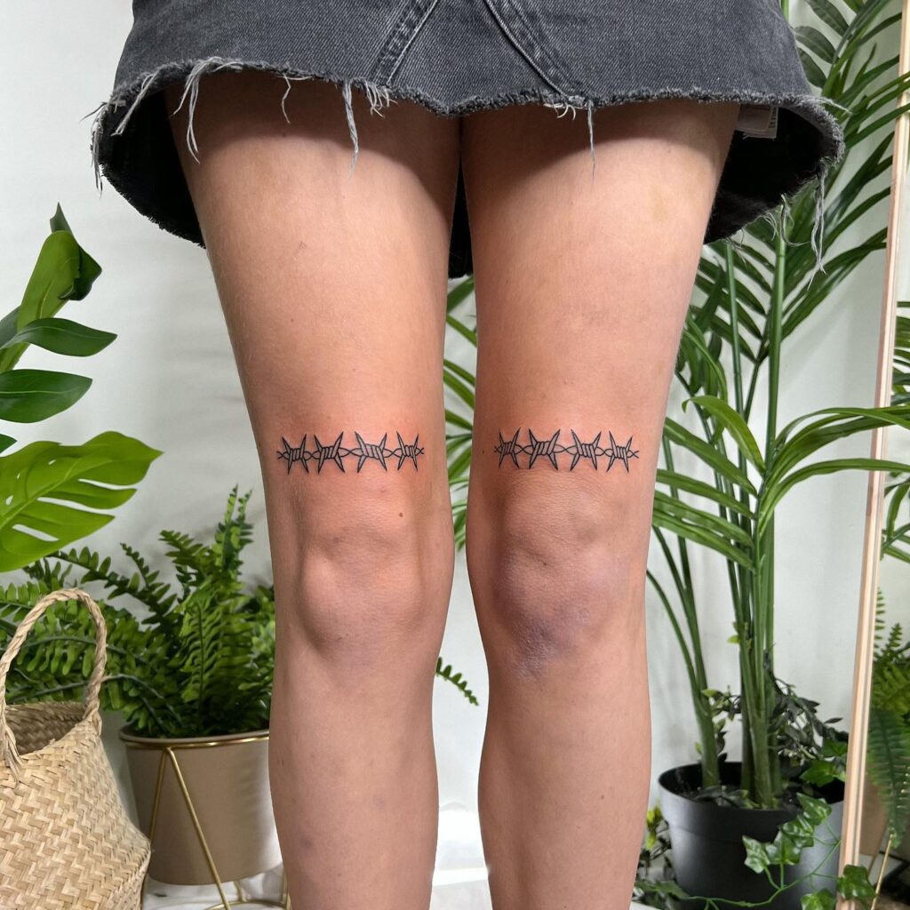 Barbed wire tattoo above knee on both legs edgy elegance for women