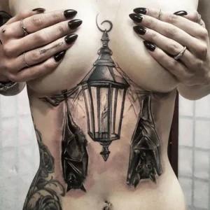 Bat under breast tattoo 1